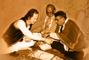 Ustad Mushtaq Ali Khan ties the traditional thread (gandha) which binds the relationship between master and student. The renowned D.T. Joshi, disciple of Enayet Khan, looks on Ustad Mushtaq Ali Khan ties the traditional thread (gandha) which binds the relationship between master and student. The renowned D.T. Joshi, disciple of Enayet Khan, looks on